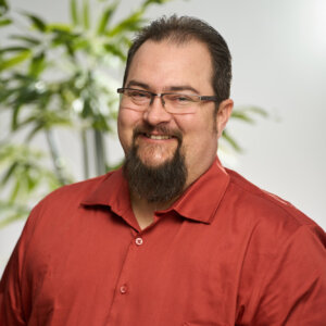 A headshot of Dan Bourrier smiling