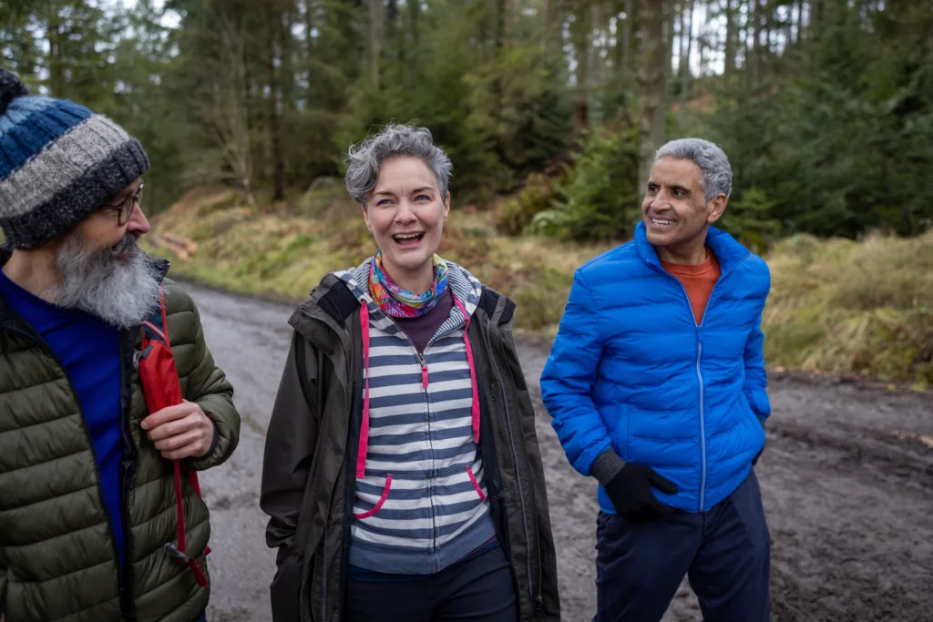 Three older adults going for a walk in spring